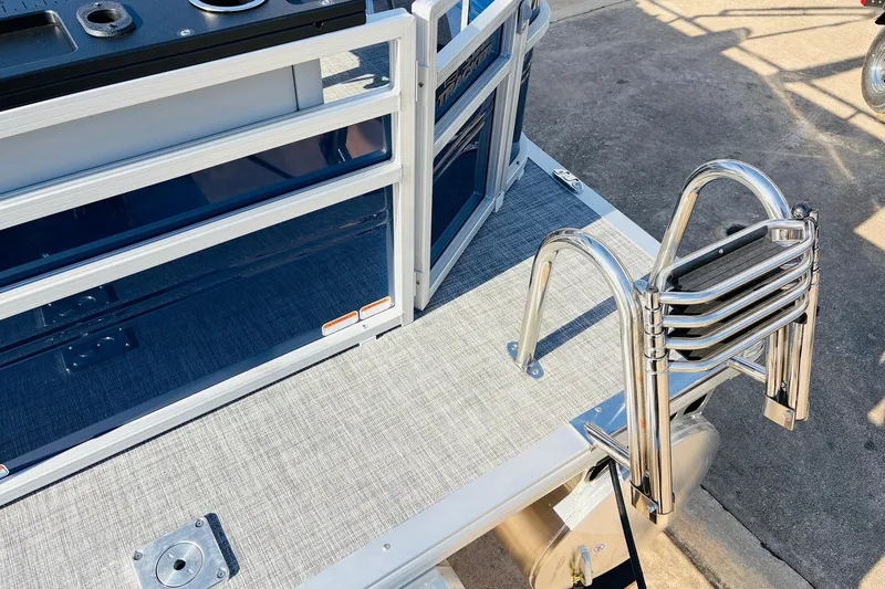 Slide: The Image of 2026 Sun Tracker SportFish 20 DLX boat with stainless steel ladder and sleek deck design. - 48