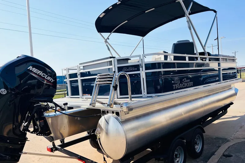 Slide: The Image of 2026 Sun Tracker SportFish 20 DLX pontoon boat with Mercury engine on trailer. - 6