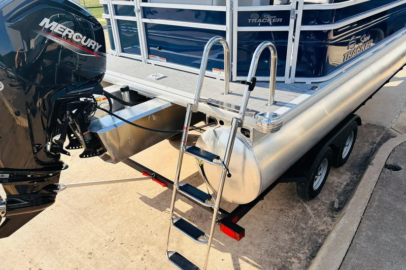 Slide: The Image of 2026 Sun Tracker SportFish 20 DLX pontoon boat with Mercury engine and trailer. - 9