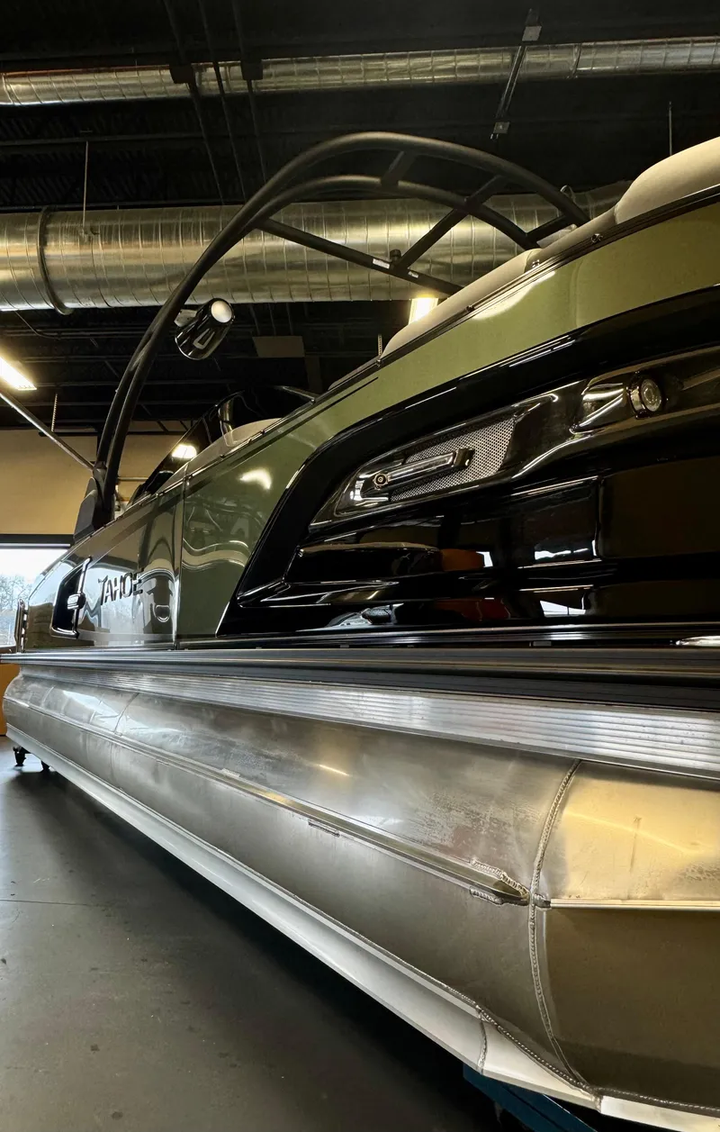 Slide: The Image of 2025 Tahoe Pontoon Grand Tahoe LTD Versatile Rear Bench Windshield in showroom. - 2
