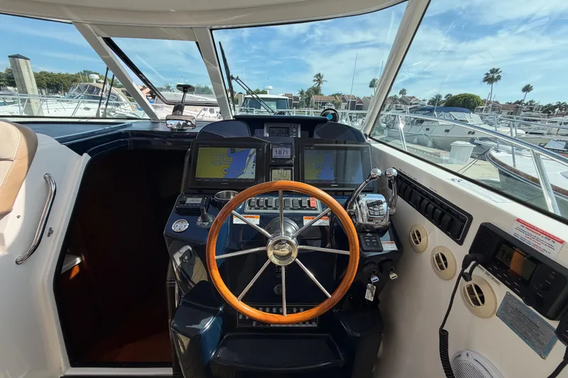 Slide: The Image of Helm of 2013 Tiara Yachts 3600 Coronet with navigation screens and steering wheel. - 11