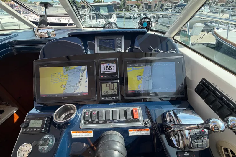 Slide: The Image of Control panel of a 2013 Tiara Yachts 3600 Coronet with navigation screens and controls. - 12