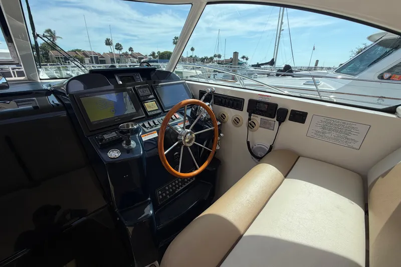 Slide: The Image of Helm of 2013 Tiara Yachts 3600 Coronet with navigation screens and wooden steering wheel. - 13
