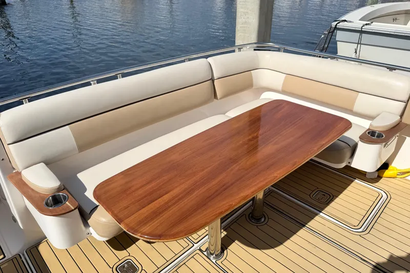 Slide: The Image of Luxury seating area on 2013 Tiara Yachts 3600 Coronet with wooden table. - 18