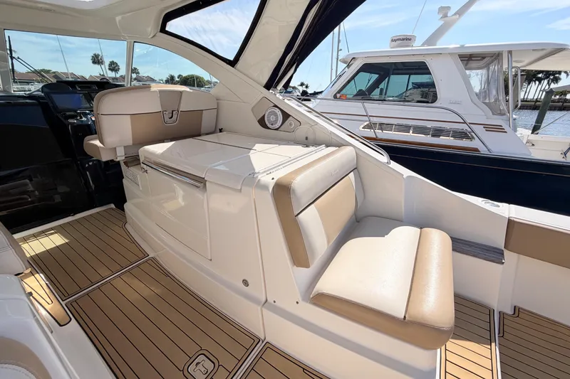 Slide: The Image of 2013 Tiara Yachts 3600 Coronet interior with beige seating and wood flooring. - 20