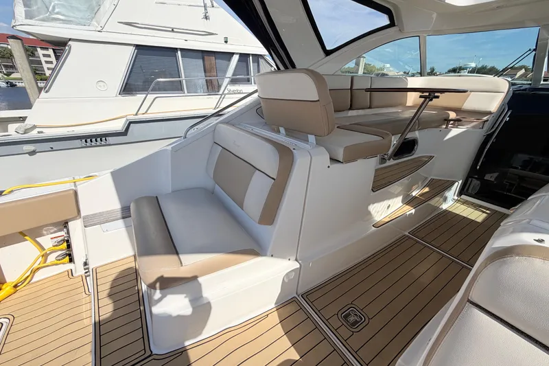 Slide: The Image of 2013 Tiara Yachts 3600 Coronet interior with beige seating and wooden flooring. - 21