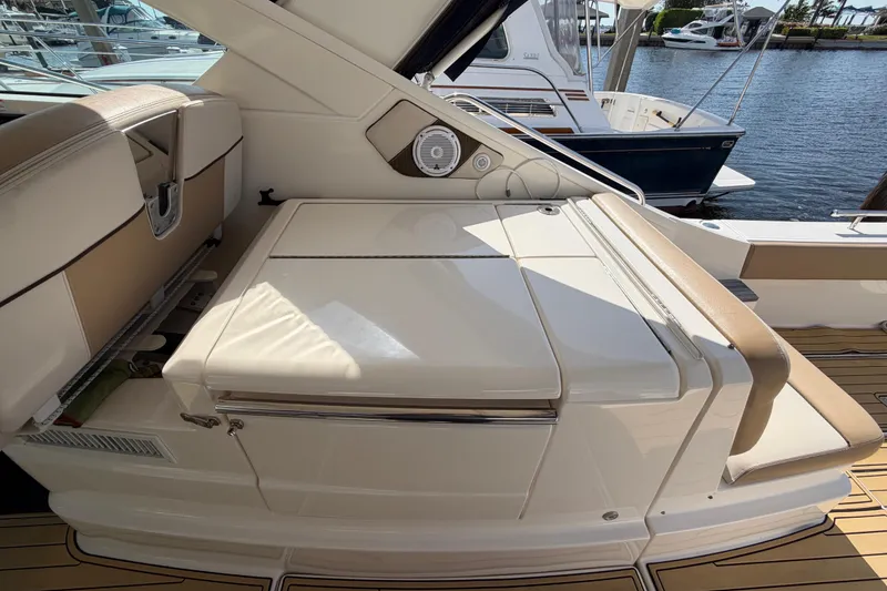 Slide: The Image of 2013 Tiara Yachts 3600 Coronet interior with cushioned seating and sleek design. - 22