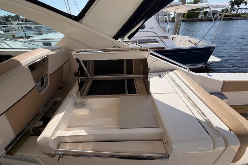 Slide: The Image of 2013 Tiara Yachts 3600 Coronet with outdoor sink and grill, docked by the water. - 23