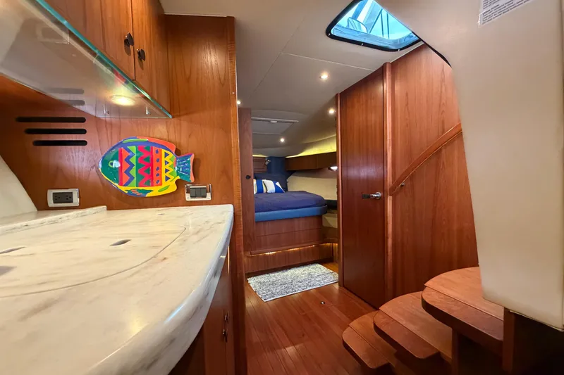 Slide: The Image of Interior of 2013 Tiara Yachts 3600 Coronet with wooden cabinetry and colorful fish decor. - 27