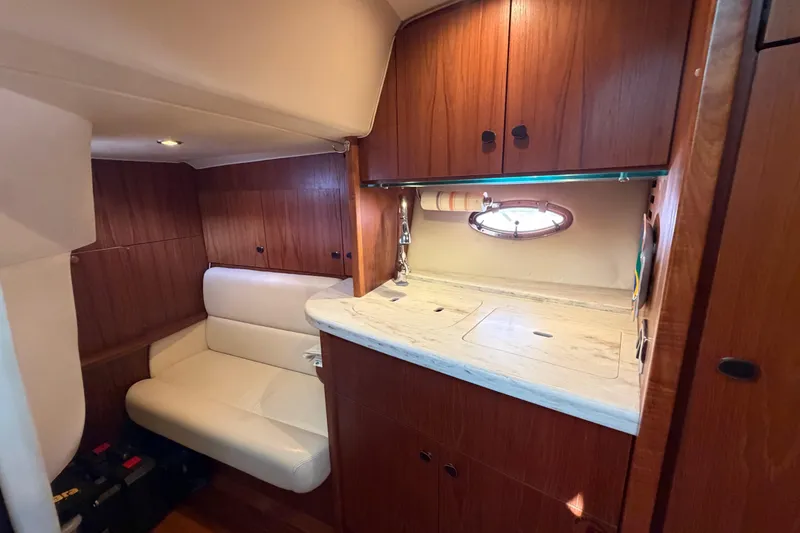 Slide: The Image of 2013 Tiara Yachts 3600 Coronet cabin interior with wood cabinetry and seating. - 29