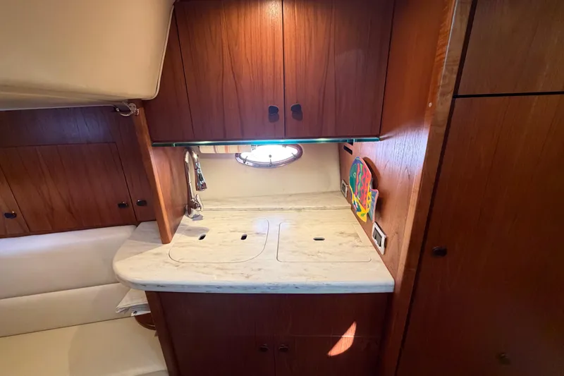 Slide: The Image of 2013 Tiara Yachts 3600 Coronet interior with wooden cabinetry and marble countertop. - 30