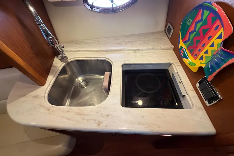 Slide: The Image of Compact kitchen area in 2013 Tiara Yachts 3600 Coronet with sink and colorful fish decor. - 31