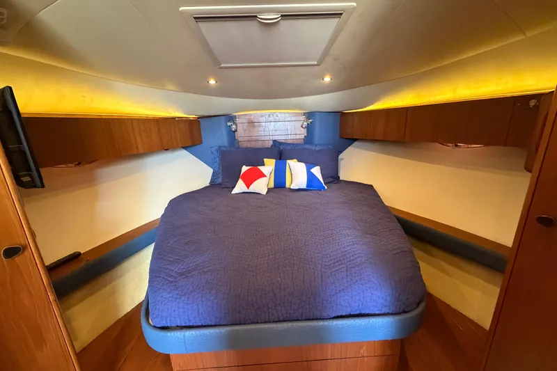Slide: The Image of Luxurious cabin interior of 2013 Tiara Yachts 3600 Coronet with cozy bedding and ambient lighting. - 34
