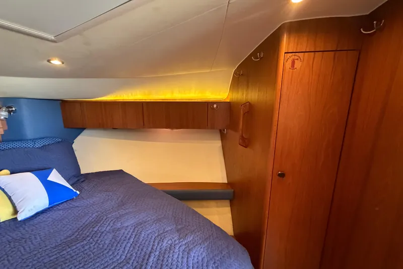 Slide: The Image of Cozy cabin interior of 2013 Tiara Yachts 3600 Coronet with wood paneling and bedding. - 36
