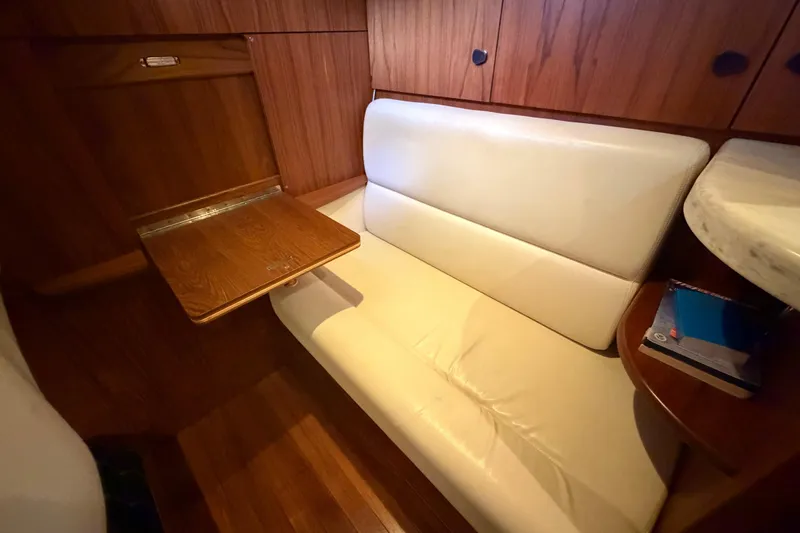 Slide: The Image of Interior of 2013 Tiara Yachts 3600 Coronet with white seating and wooden table. - 41