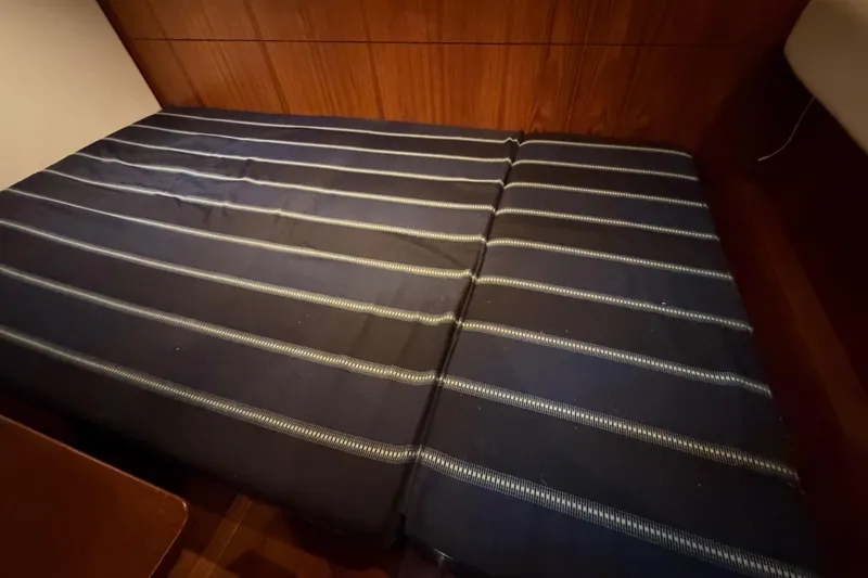 Slide: The Image of Interior cabin bed with striped bedding on a 2013 Tiara Yachts 3600 Coronet. - 42