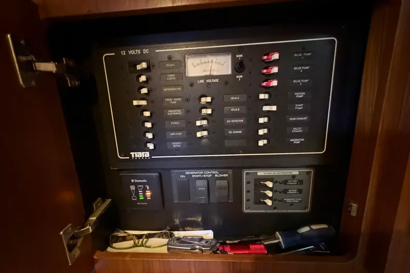 Slide: The Image of Electrical panel of a 2013 Tiara Yachts 3600 Coronet, featuring various switches and controls. - 44