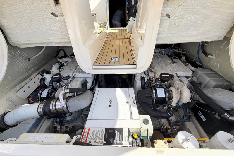 Slide: The Image of Engine room of a 2013 Tiara Yachts 3600 Coronet, showcasing dual engines and mechanical components. - 49