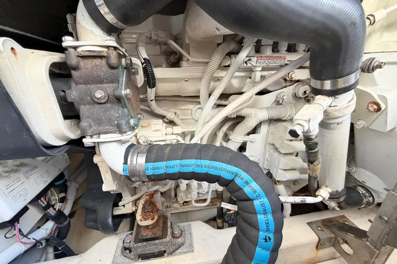 Slide: The Image of Engine compartment of a 2013 Tiara Yachts 3600 Coronet, showcasing hoses and components. - 52