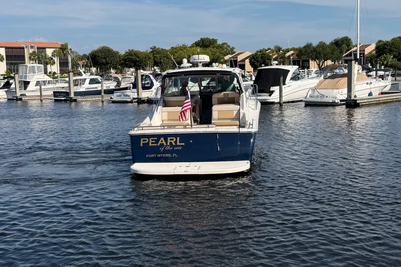 Slide: The Image of 2013 Tiara Yachts 3600 Coronet in marina, Fort Myers, FL, with American flag. - 6