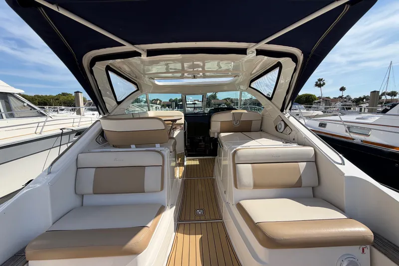 Slide: The Image of 2013 Tiara Yachts 3600 Coronet interior with beige seating and wooden flooring. - 9