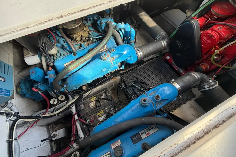Slide: The Image of Engine compartment of a 1989 Wellcraft 3400 Gran Sport boat, featuring blue and red components. - 10