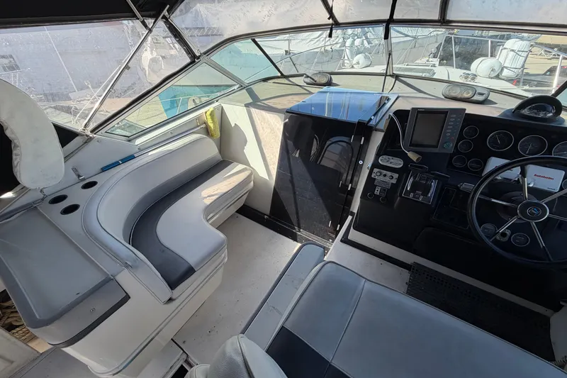 Slide: The Image of 1989 Wellcraft 3400 Gran Sport boat cockpit with steering wheel and seating area. - 11