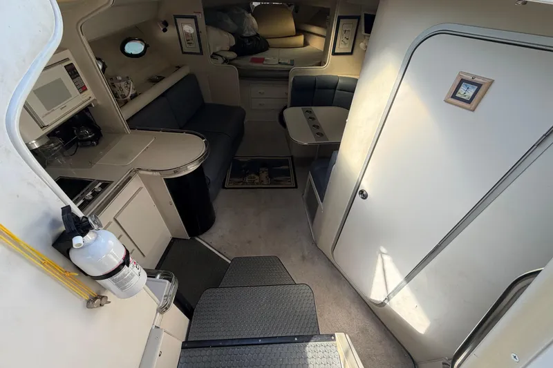 Slide: The Image of Interior of 1989 Wellcraft 3400 Gran Sport boat with kitchenette and seating area. - 14