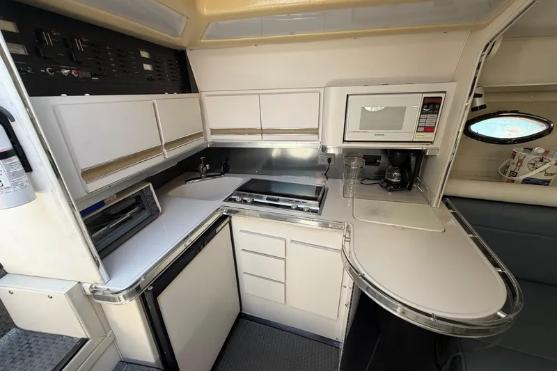Slide: The Image of 1989 Wellcraft 3400 Gran Sport yacht kitchen with modern appliances and sleek cabinetry. - 16