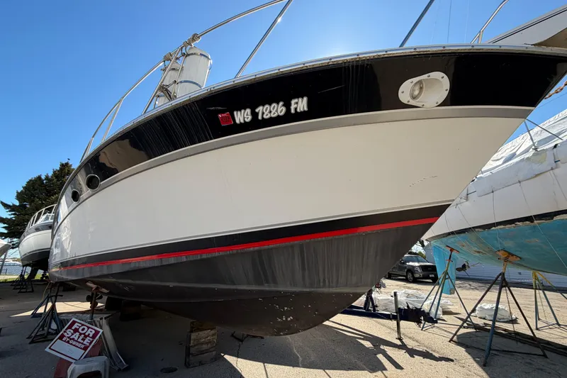 Slide: The Image of 1989 Wellcraft 3400 Gran Sport boat for sale, displayed on dry dock. - 2