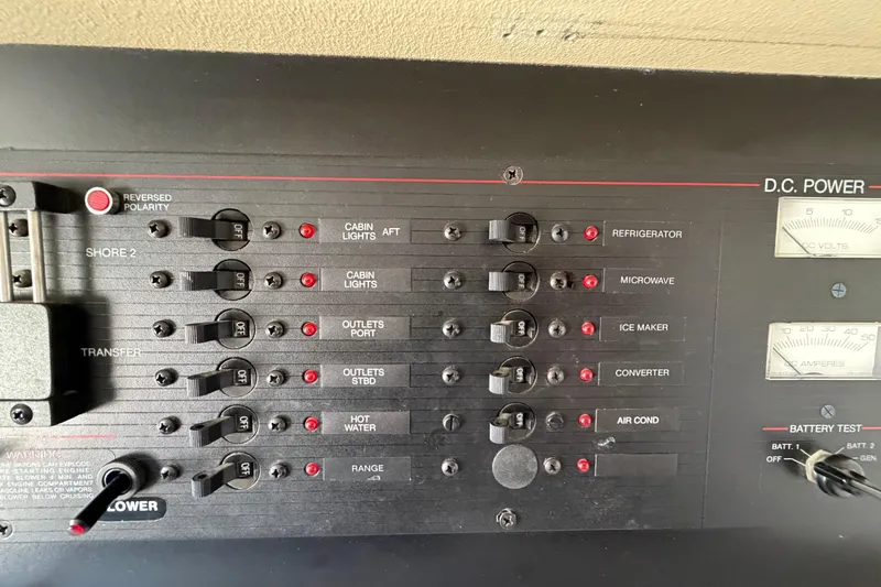 Slide: The Image of Control panel of a 1989 Wellcraft 3400 Gran Sport boat, showing various switches and gauges. - 23
