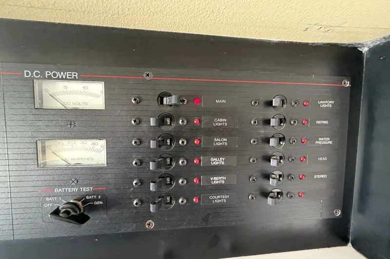 Slide: The Image of 1989 Wellcraft 3400 Gran Sport DC power panel with switches and gauges. - 24
