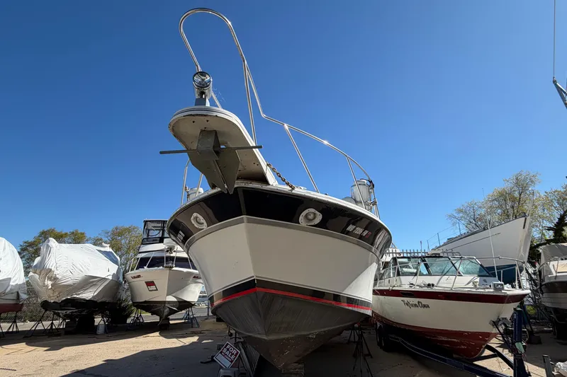 Slide: The Image of 1989 Wellcraft 3400 Gran Sport boat on display under clear blue sky. - 3
