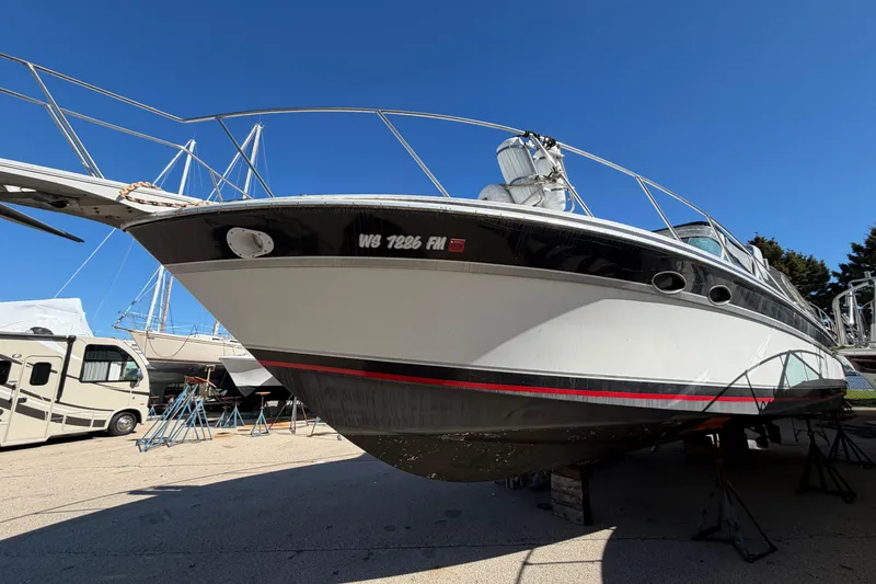 Slide: The Image of 1989 Wellcraft 3400 Gran Sport boat on dry dock under clear blue sky. - 4