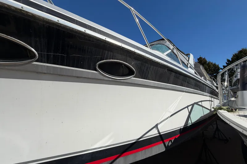 Slide: The Image of 1989 Wellcraft 3400 Gran Sport boat docked under clear blue sky. - 6