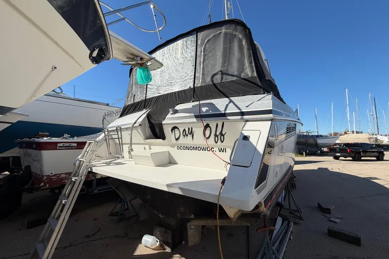 Slide: The Image of 1989 Wellcraft 3400 Gran Sport boat named "Day Off" in a marina setting. - 7