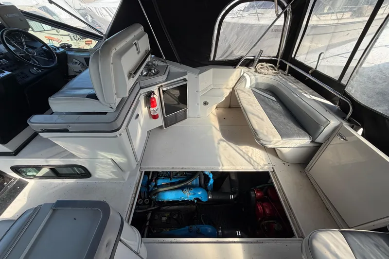 Slide: The Image of 1989 Wellcraft 3400 Gran Sport boat interior with seating, engine access, and helm. - 8