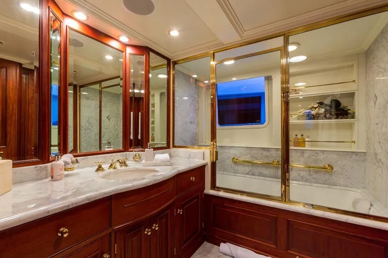 Slide: The Image of Luxurious yacht bathroom with marble countertops, gold fixtures, and elegant wood cabinetry, Palmer Johnson 1997. - 10