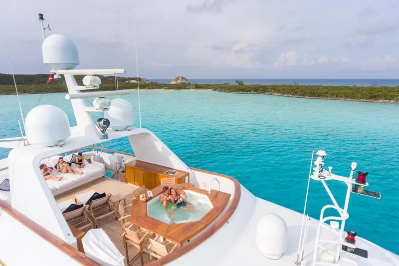 Slide: The Image of Luxurious 1997 Palmer Johnson yacht with jacuzzi, lounging area, and stunning turquoise waters. - 21