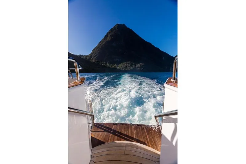 Slide: The Image of Palmer Johnson Semi-Displacement yacht cruising with scenic mountain view, 1997 model. - 25
