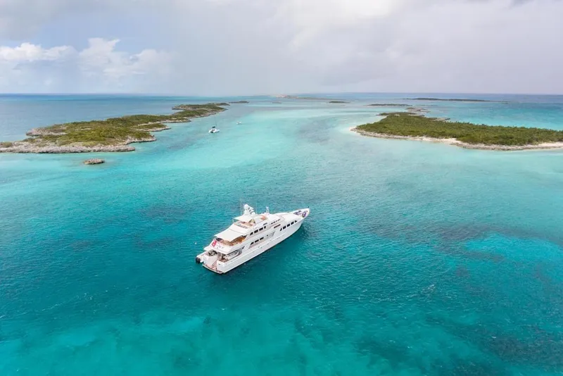 Slide: The Image of Luxurious 1997 Palmer Johnson yacht cruising in turquoise waters near tropical islands. - 28