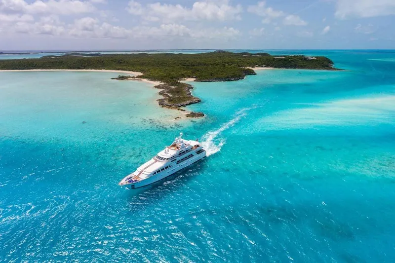 Slide: The Image of Luxurious 1997 Palmer Johnson Semi-Displacement yacht cruising in turquoise waters near a tropical island. - 29