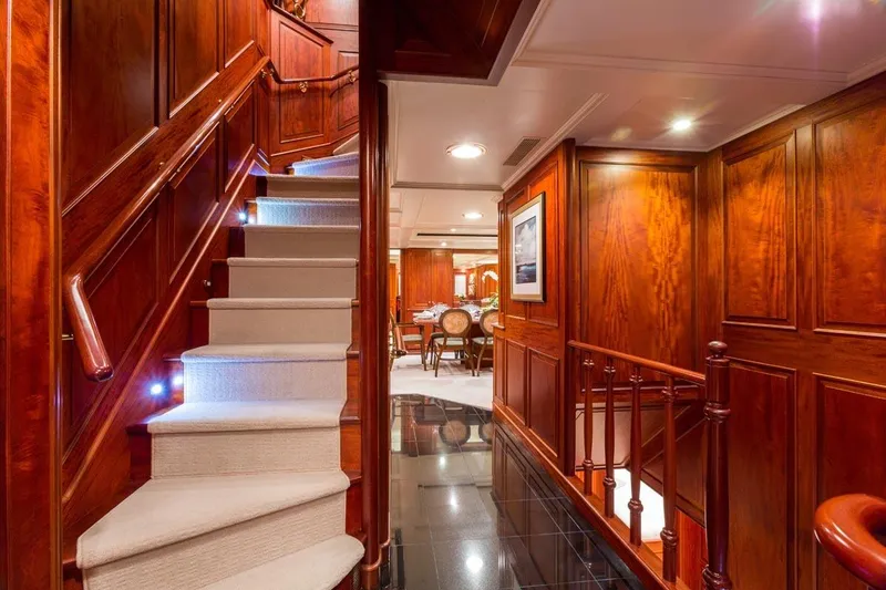 Slide: The Image of Luxurious wooden interior of 1997 Palmer Johnson Semi-Displacement yacht with elegant staircase and dining area. - 6