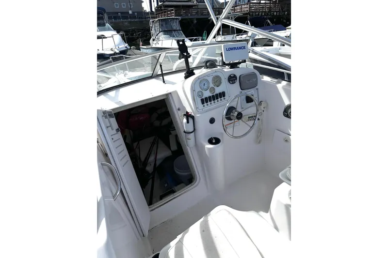 Slide: The Image of 2006 Pro-Line 21 Walkaround boat cockpit with steering wheel and navigation equipment. - 2