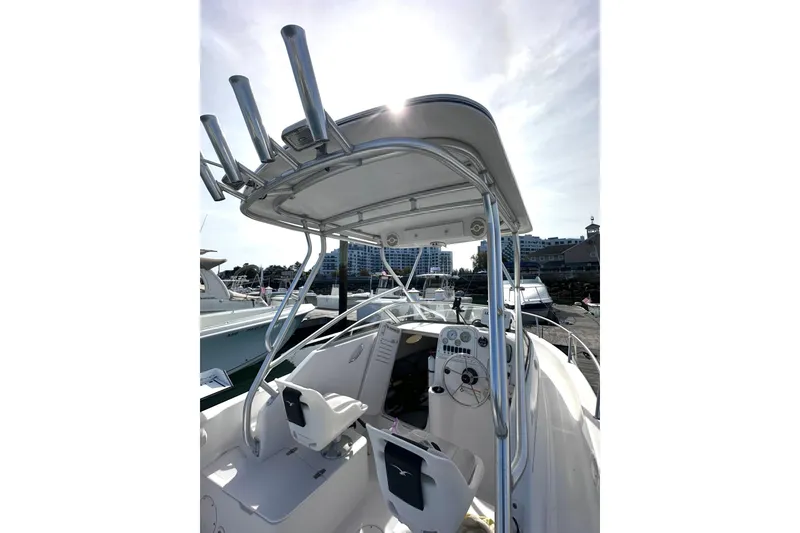 Slide: The Image of 2006 Pro-Line 21 Walkaround boat interior with helm and seating, docked at marina. - 5