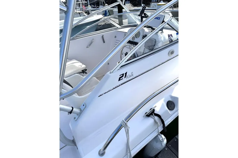 Slide: The Image of 2006 Pro-Line 21 Walkaround boat interior with steering console and seating. - 6
