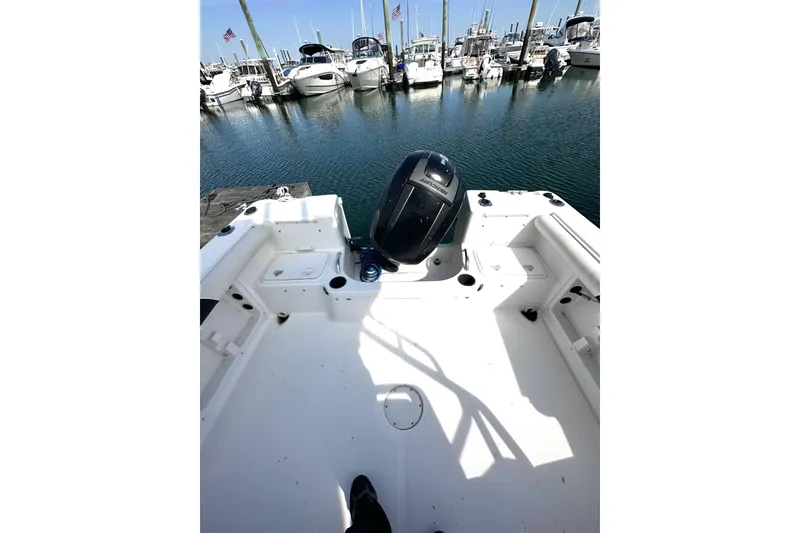 Slide: The Image of 2006 Pro-Line 21 Walkaround boat docked at marina with outboard motor. - 8