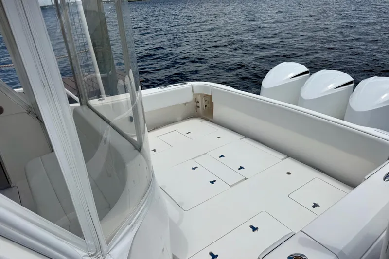 Slide: The Image of 2013 Intrepid 430 Sport Yacht deck with seating and triple outboard motors. - 10