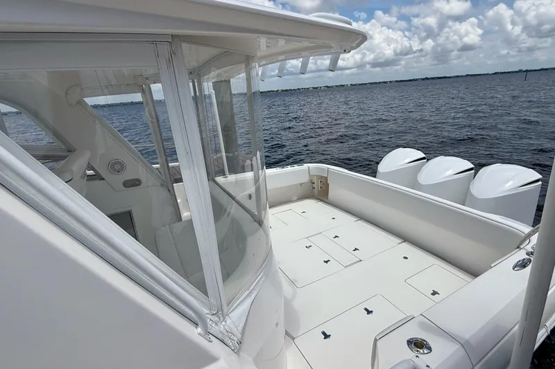 Slide: The Image of 2013 Intrepid 430 Sport Yacht deck with ocean view and four engines. - 11