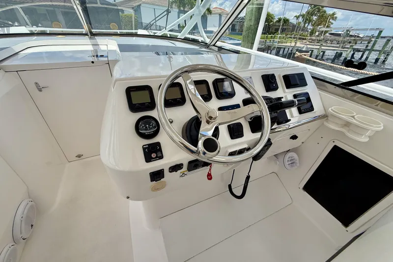 Slide: The Image of Helm of 2013 Intrepid 430 Sport Yacht with steering wheel and control panel. - 17